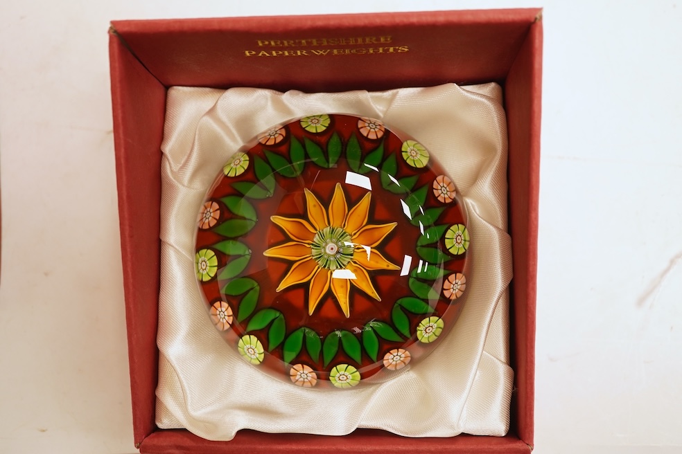 Three boxed Perthshire paperweights together with two further examples, unboxed, some millefiori, largest 7cm in diameter (5)